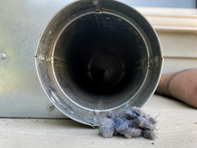 Scituate Dryer Vent Cleaning technician using specialized equipment to clear severe dryer vent blockage in Scituate